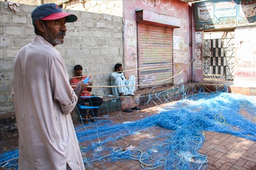 A fisherman explaining the process of creating fishing nets
