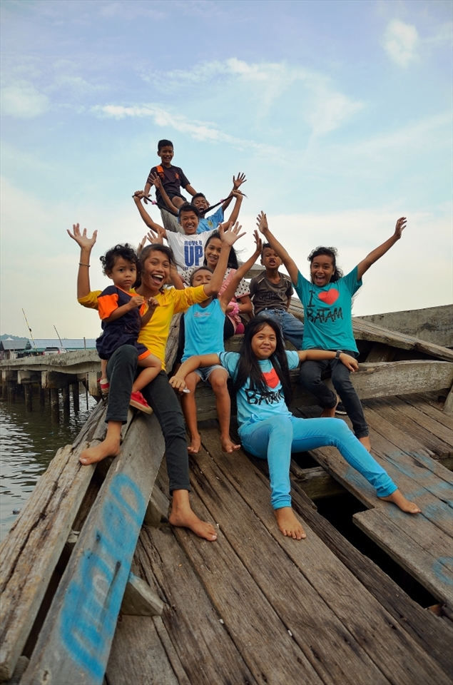 Kids playing on the abandoned wooden ship, they play here everyday after school, such a joy in childhood