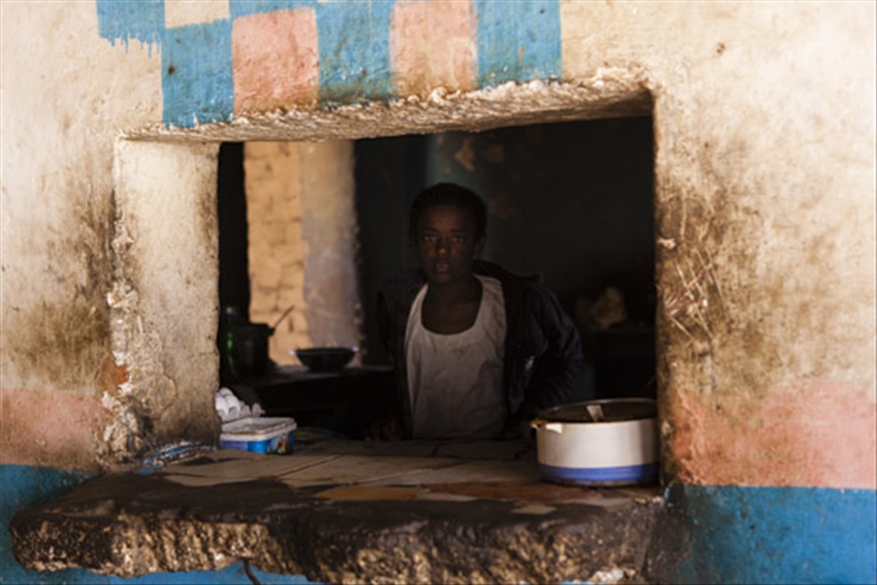 A boy sells us lunch from his home in northern Sudan