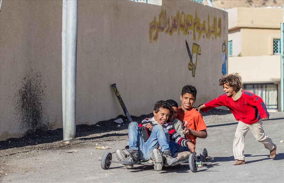 These kids having a great time on their makeshift go kart.