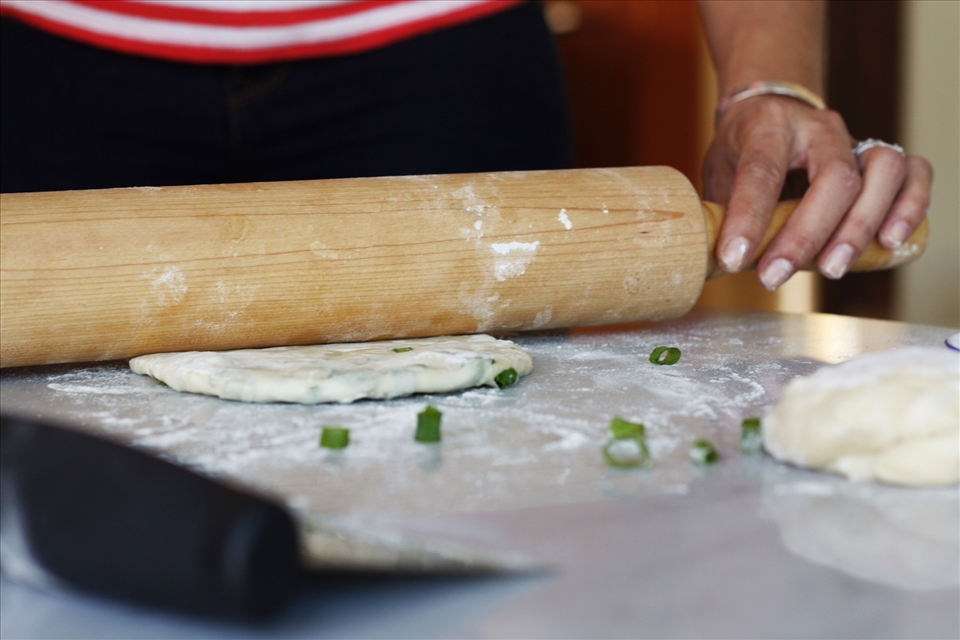 rolling scallions in and pancakes out