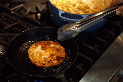 frying pancake as stew awaits