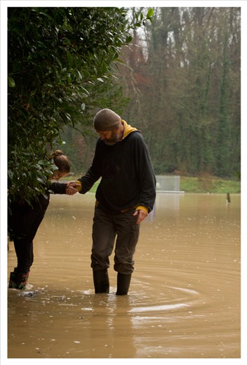 My father helping my sister to cross the water