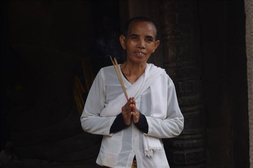 A buddhist praying in a hidden temple