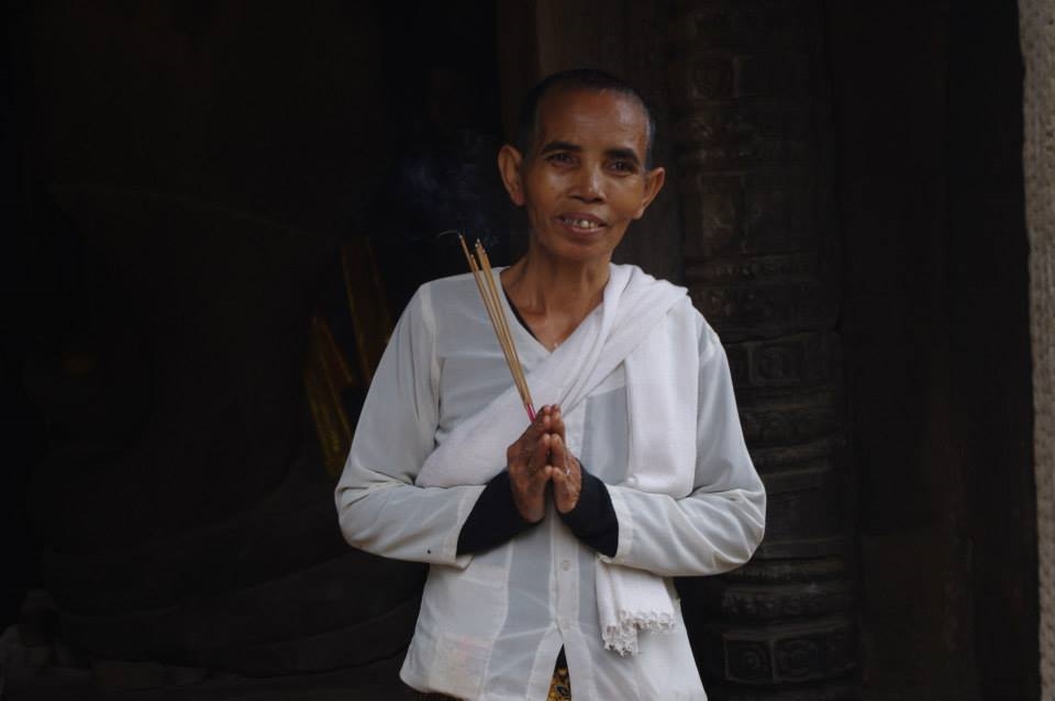 A buddhist praying in a hidden temple