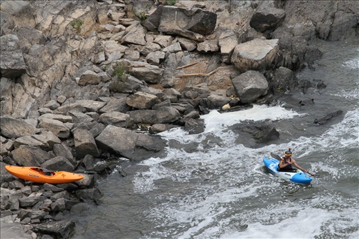 Behind him, he's confronted by a haunting image as the waves push him closer.