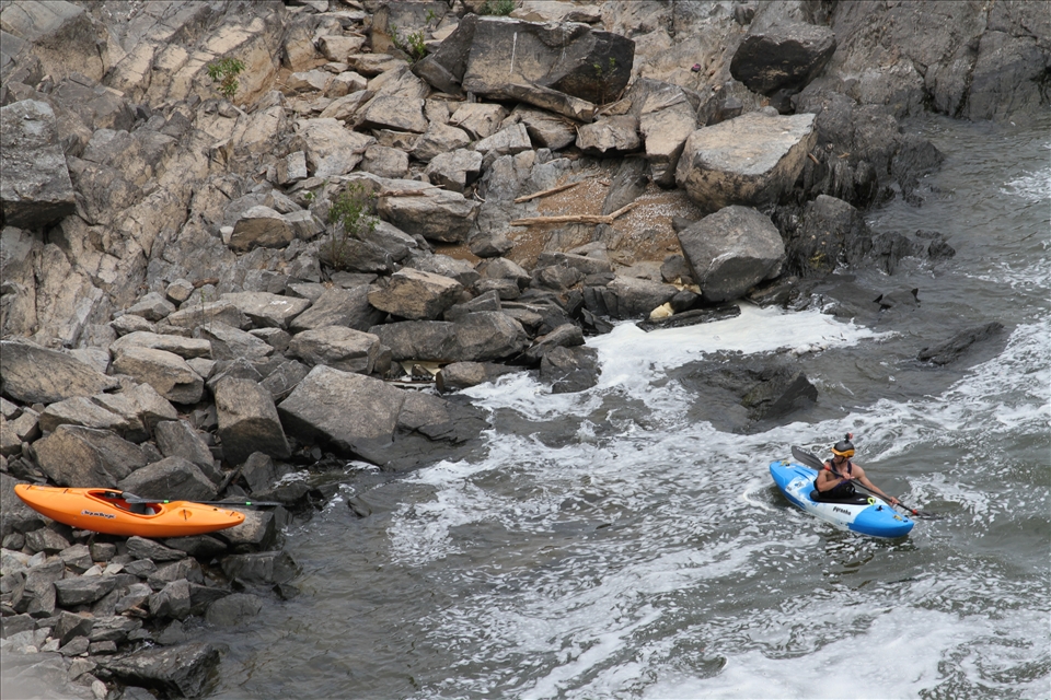 Behind him, he's confronted by a haunting image as the waves push him closer.