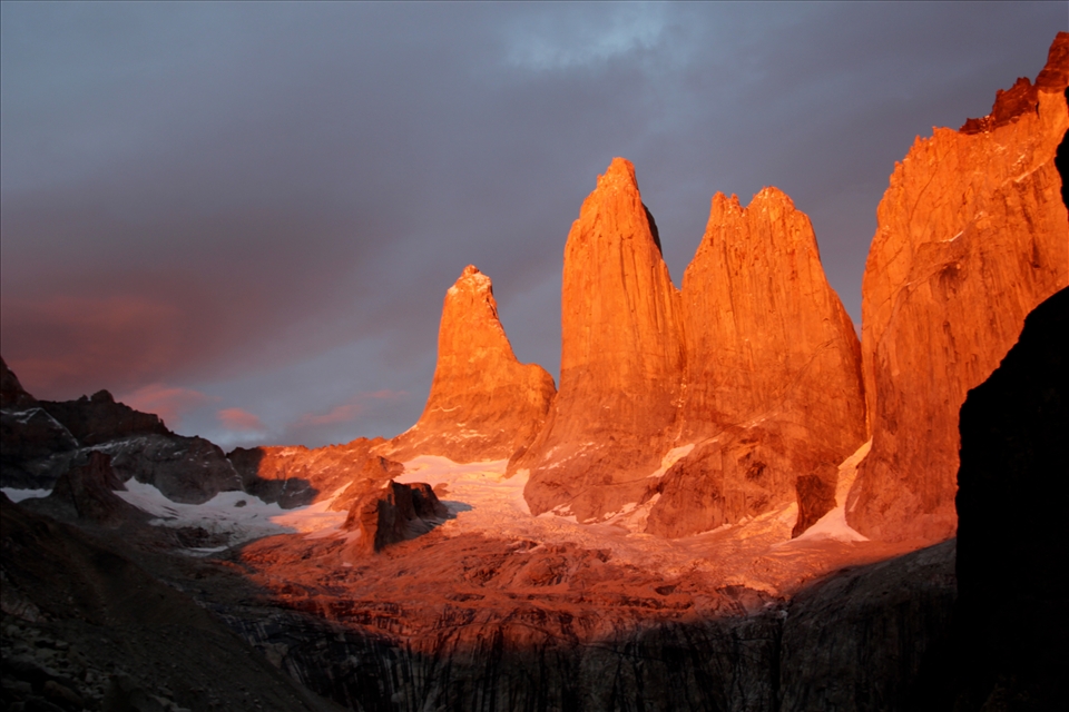 The rising sun spotlights Las Torres bringing warmth to the cold granite face.
