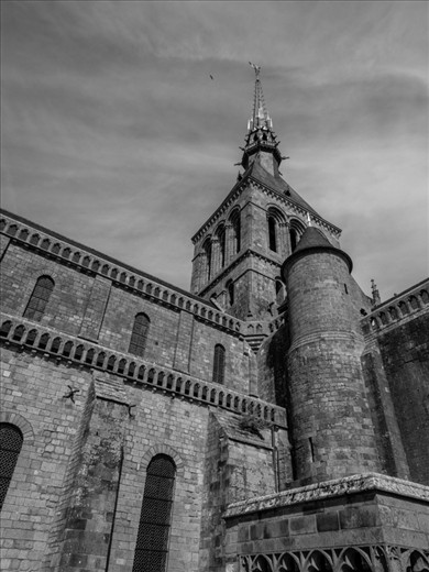 The bronze statue of Saint Michael slaying a dragon soars over the medieval city