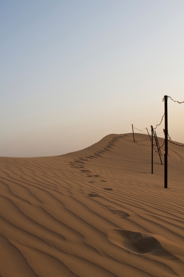The edge of a remote desert camp shows sights of human life even in this harsh environment