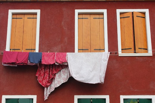 Burano is a calm and sleepy island in the Venetian Lagoon. I visited in September, the late summer attracting fewer tourists. I decided an appropriate way of capturing the tranquility of the place and time was by focusing on the abundance of washing that hung beneath the first floor of almost every bright and colourful home that I came across.