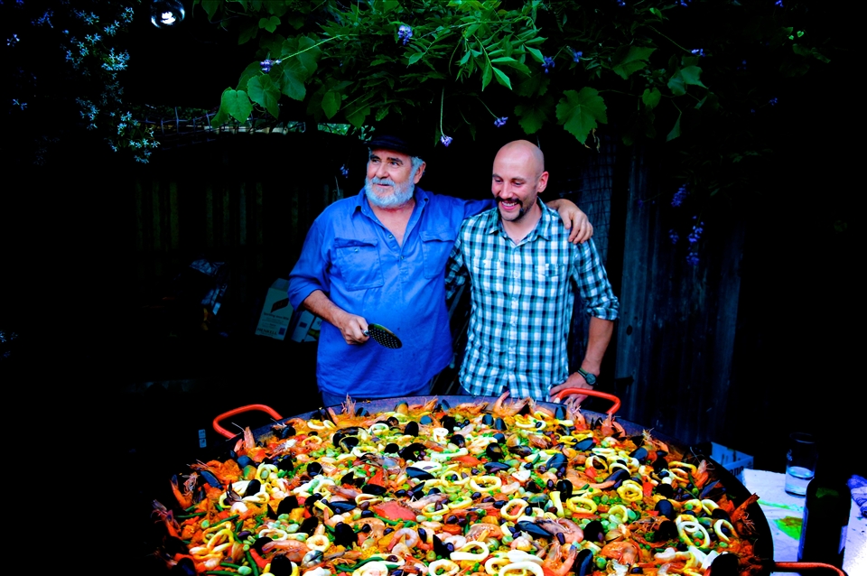 The paella man's apprentice. Delicious paella being served by these two.