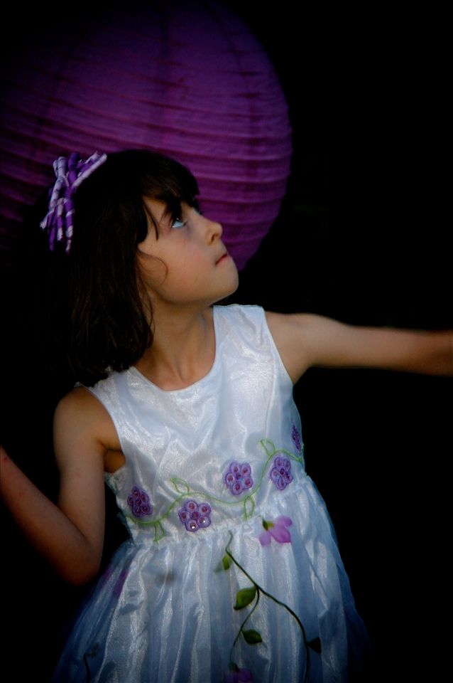 Eyes on the shuttlecock. A little girl's determination to win the game.