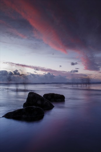 This photo was taken in Muriwai beach New Zealand. As u can see some shadow of people, this people was walking around the shore and getting some shells during the sunset. 
