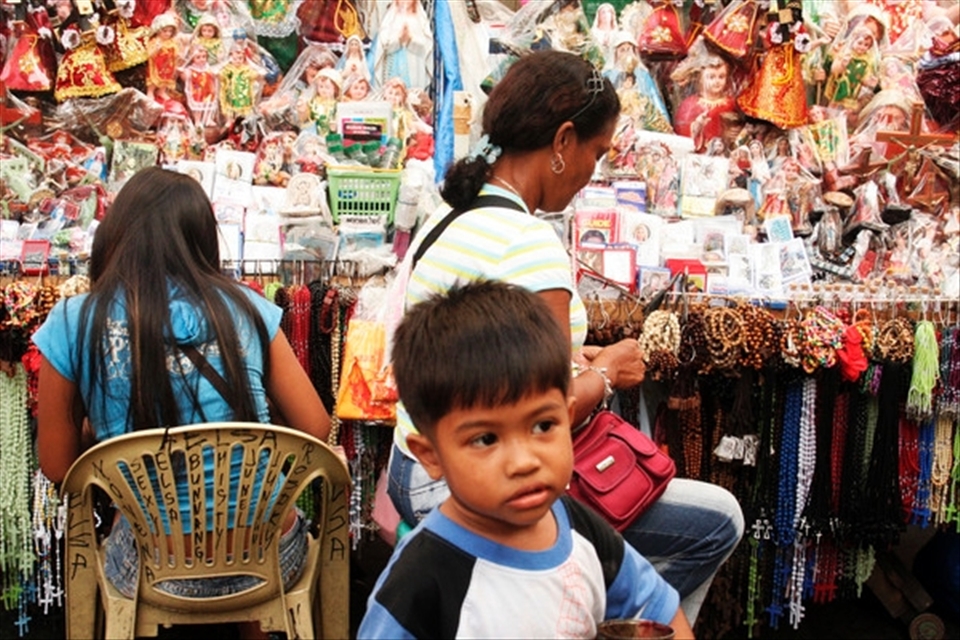 A lot of vendors in Quiapo make a living from selling religious paraphernalia and the children work with them. 