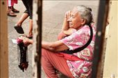 This woman is taking a rest after a long day of selling booklets and scapulars by the church steps. : by bernicebeltran, Views[577]