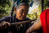 There were about 20 travellers who came and left when I was in Kalinga. They all came to get tattoos from Fang-Od. The tattoo is done using two bamboo sticks, one of which has a thorn attached to it while the other is used for tapping. The ink is made of soot. This is a photograph of her giving a tattoo to one of the travelers who came to visit her. : by bernicebeltran, Views[940]