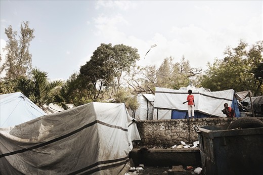 In the aftermath of the quake, tent cites were erected all over the country like this one near Pétionville.  These boys are seen playing with a kite built from the still large quantities of garbage left laying around Haiti.  