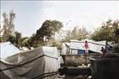 In the aftermath of the quake, tent cites were erected all over the country like this one near Pétionville.  These boys are seen playing with a kite built from the still large quantities of garbage left laying around Haiti.  : by beyoustill, Views[289]