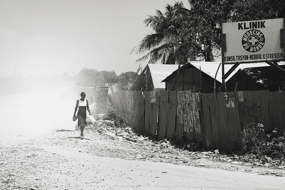 Since the majority of the city was heavily damaged from the quake, settlements popped up further and further away from the city. A Haitian women walks by a clinic built about an hour outside Port Au Prince.