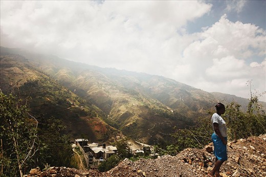 A view rarely shown by the media.  A women waits for a bus in the mountains surrounding Port Au Prince.