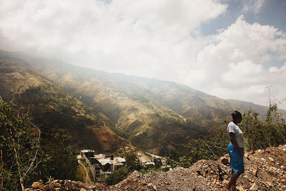 A view rarely shown by the media.  A women waits for a bus in the mountains surrounding Port Au Prince.