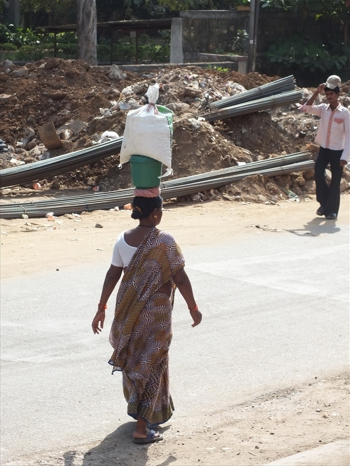A loving mother carrying 15lbs in the blistering heat to bring her family food