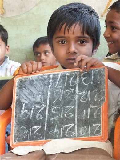 Education is limited in India- he's carrying quite the responsibility and it's written on his face