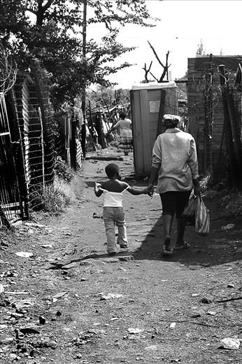 The streets of Soweto can be a maze and have many different roads. We were walking around and I was lucky to glance this magic moment of a mother walking her daughter home