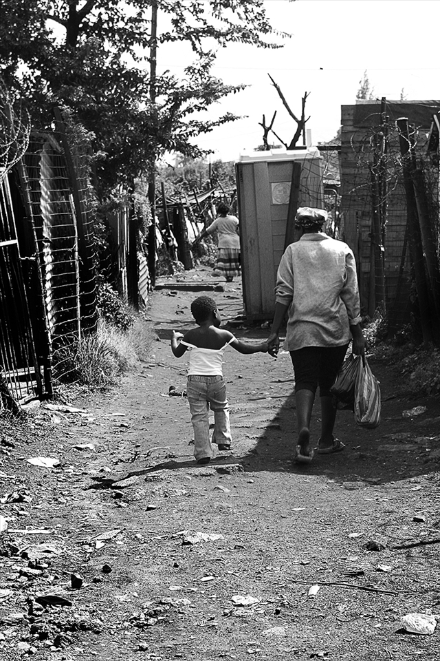 The streets of Soweto can be a maze and have many different roads. We were walking around and I was lucky to glance this magic moment of a mother walking her daughter home