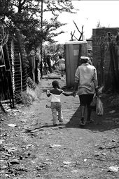 The streets of Soweto can be a maze and have many different roads. We were walking around and I was lucky to glance this magic moment of a mother walking her daughter home: by bigj, Views[558]