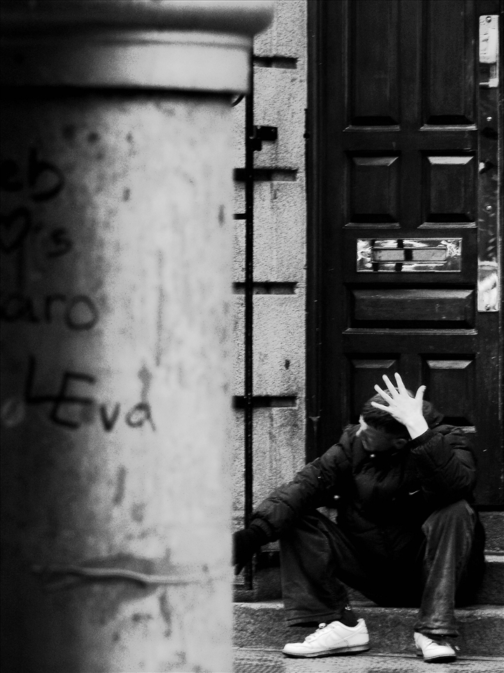 Ranting and crying to himself this man roams the street, sits and seems to be trying to explain his situation to someone who is not there.