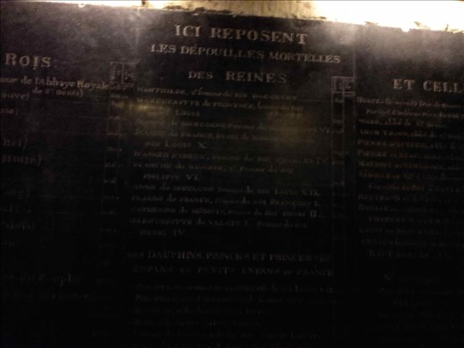 Paris -- Basilique de St Denis -- old stone sign listing who's buried in crypt