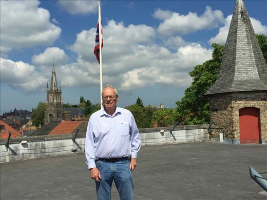 Brugge -- Bill on roof of entry port towering over house rooftops below