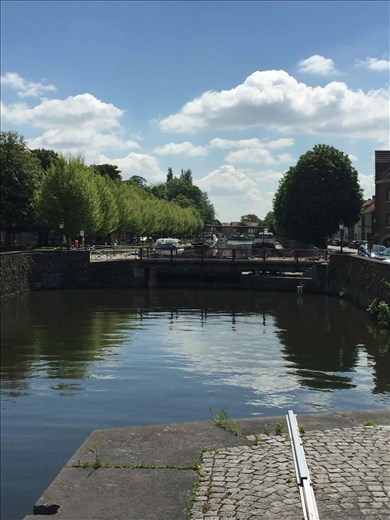 Brugge -- looking from stone landing at canal locks and bridge in background