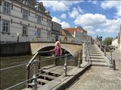 Brugge -- Cindy on wooden steps leading down to canal -- bridge in background: by billh, Views[267]