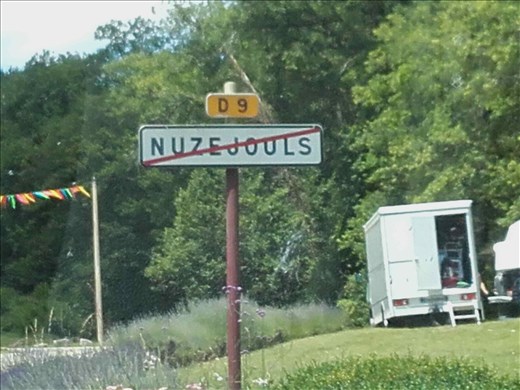 What does the line through this village sign mean?