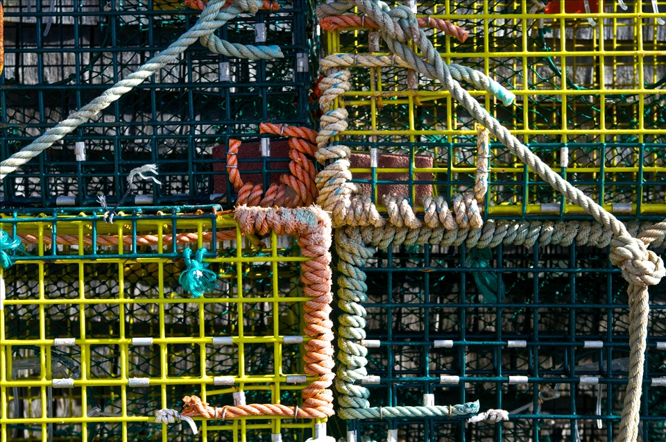 Lobster traps stacked, awaiting the coming season, which sustains many islanders