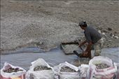 Iko, 52, the first miner in the family  gathering the stones from the river, which will be  filtered and sorted eventually according to their sizes.: by bingtajon, Views[324]