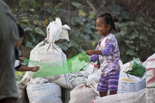 Maimai, 4, the youngest in the family playfully imitating her parents as they filter the stones. She never failed to bring a smile to everyone who will notice her antics.
