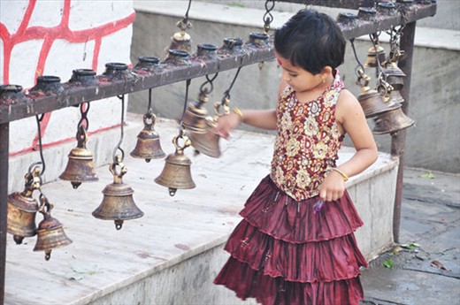 A young girl's celebratory ring in Barahi Temple, Pokhara.  
