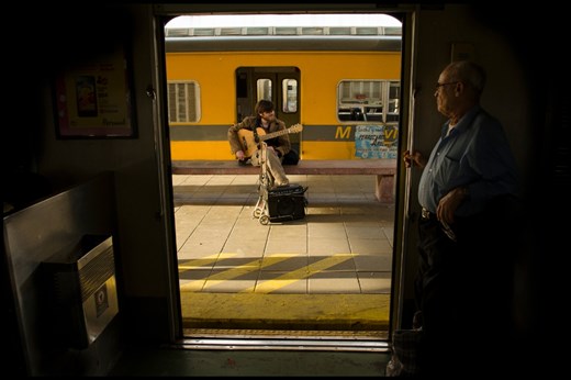 When he needs money, he goes to the train and plays the guitar. He is an artist and is passionate about it. 