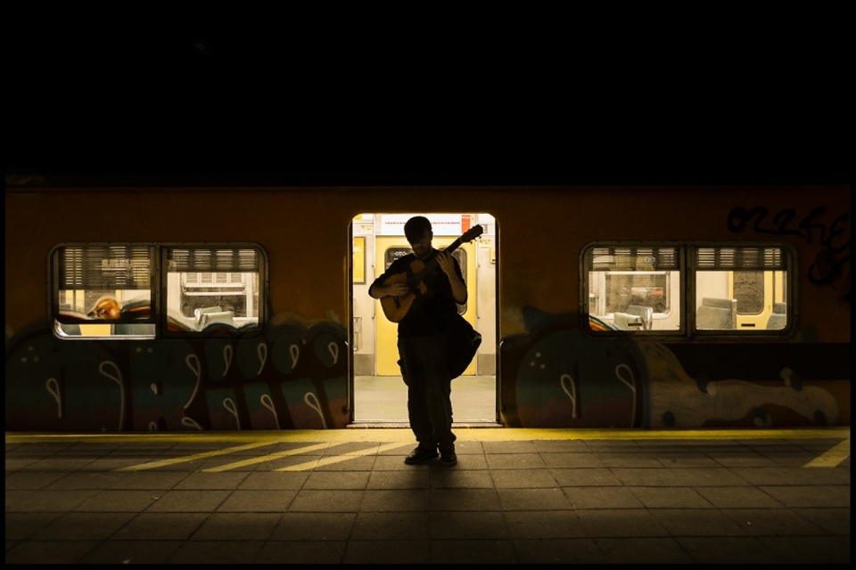 I was following him and documenting while he kept talking and telling stories. We were passing by this parked train and suddenly he stood still. Played some notes and I saw it... it was me. We were us. I saw myself, hidden in him. I asked him to move a few inches and got his whole figure framed in the back light of the train. 