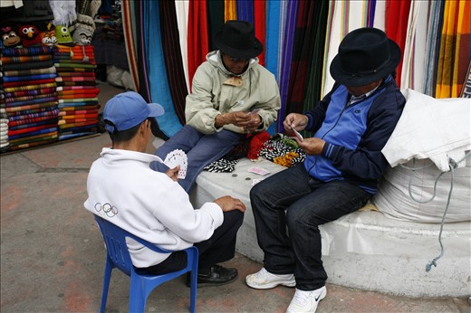Three men taking a break whilst having a game of cards