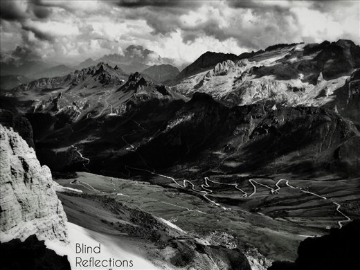 Shadows play on the Sas Becè group and the valley below, photographed from the top of Sass Pordoi, Dolomiti, Italy.