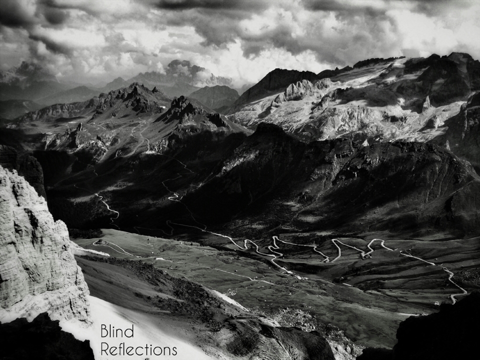 Shadows play on the Sas Becè group and the valley below, photographed from the top of Sass Pordoi, Dolomiti, Italy.