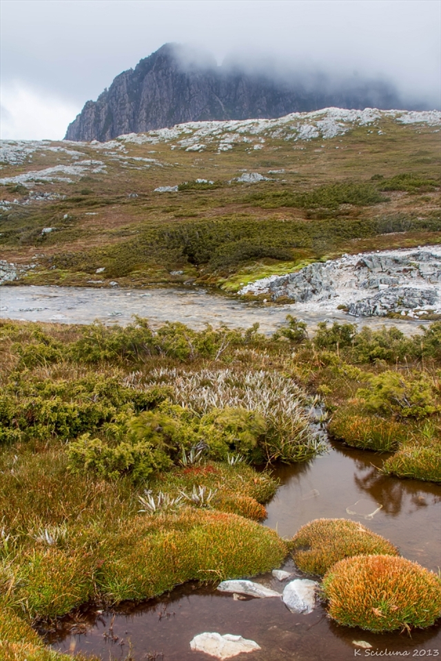 After a perilous hike around Cradle Mountain we stopped for a break, despite horrific conditions a group of hikers including myself made it around to see the summit of Cradle Mountain in front of us.  With the mist just covering Little Horn, I decided to grab my camera and get a shot, this shot just gave a sense of not only why we were there, but the conditions we all faced that day on the hike. 