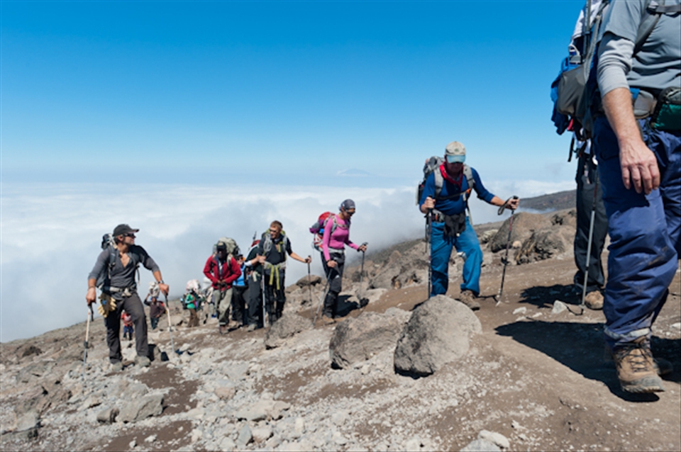 Trekking along the south side of mountain while moving from Karanga Valley up to Barafu Hut.  Now well above 4000m, the clouds are below us and we see sunshine for the first time in four days.  