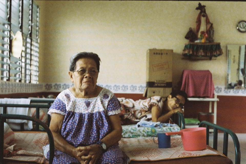 Precy and Judy are two residents who both have trouble speaking. Precy communicates through unintelligible grunts but gestures with her hands and eyes. You can tell she is joking when her grunt is followed by laughter and a smirk. Judy is a former stroke victim whose hands reach out to grasp words that seem to have escaped her. Though they cannot keep up with the banter of the other women, they both like to station themselves in the middle of things-sharing their thoughts with anyone patient enough to listen.

