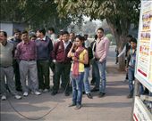 A group of men gather around a news reporter: by boessiere, Views[305]